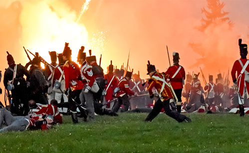 period dressed soldiers in battle with large explosion in the background