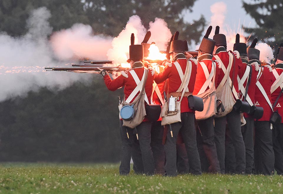 A group of soldiers shooting during the reenactment of War of 1812