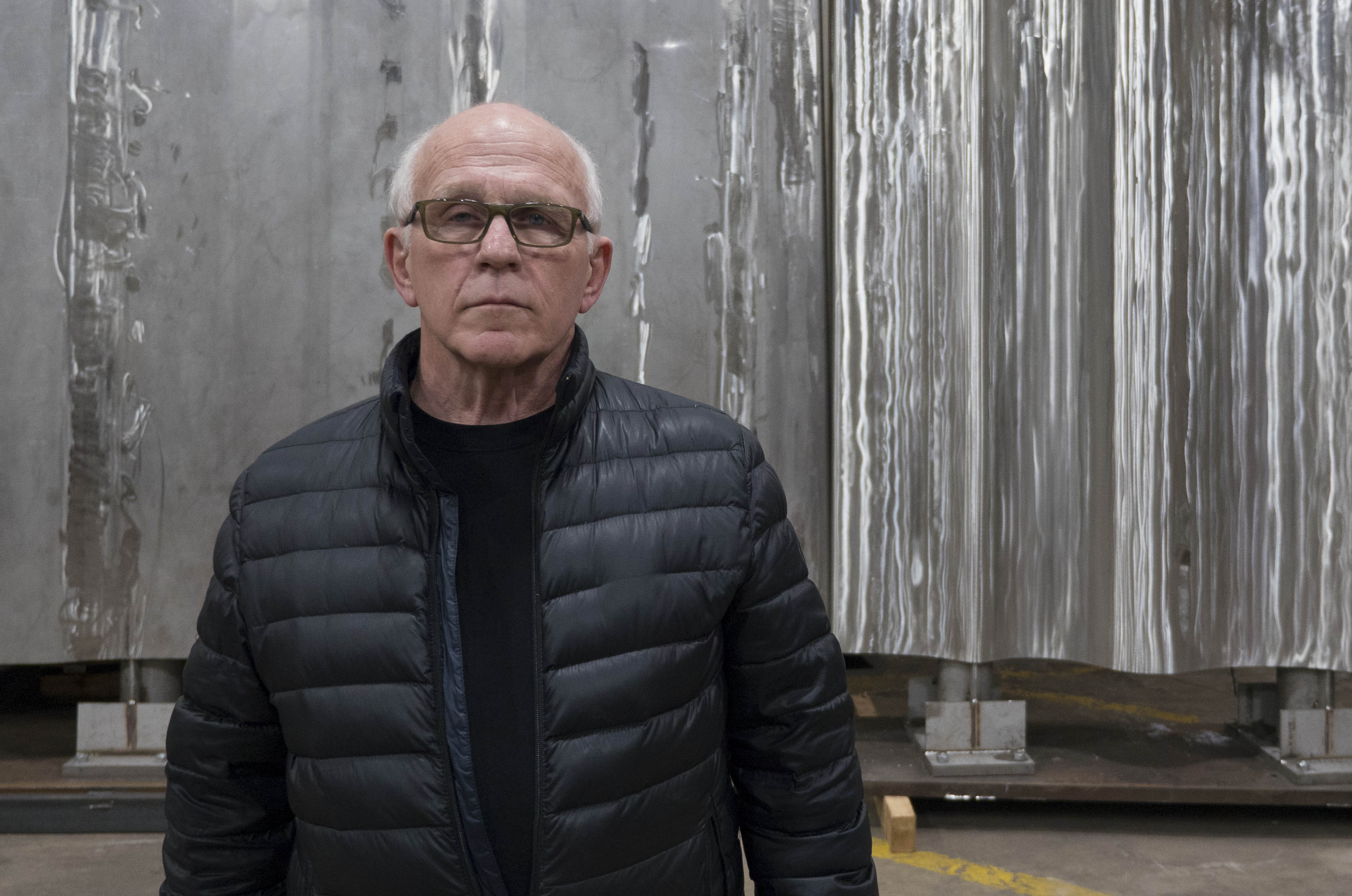 Gordon Reeve Man standing in front of sculpture