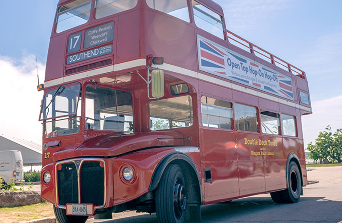 Red double deck bus parked on a road