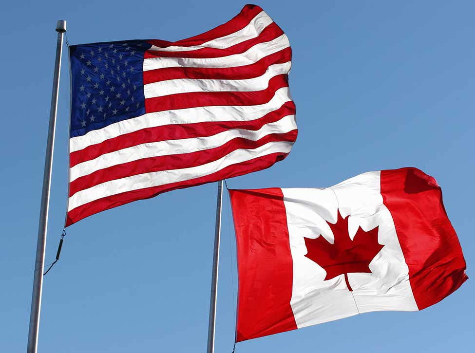 A photo of the USA and Canada flags waving