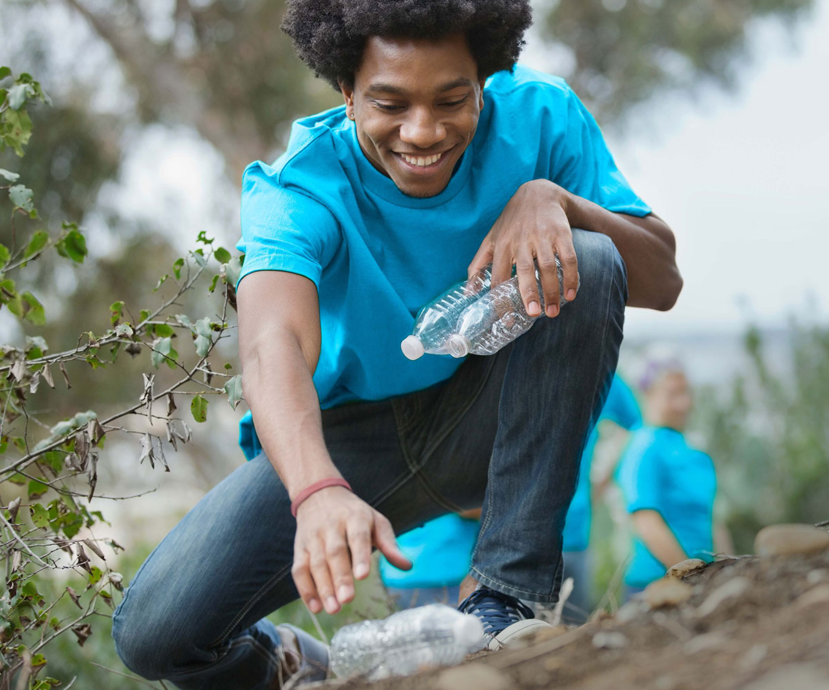 A man picking up empty water bottles at Niagara Glen Cleanup Day