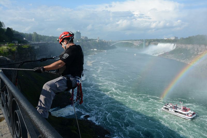 An officer repelling down the escarpment face